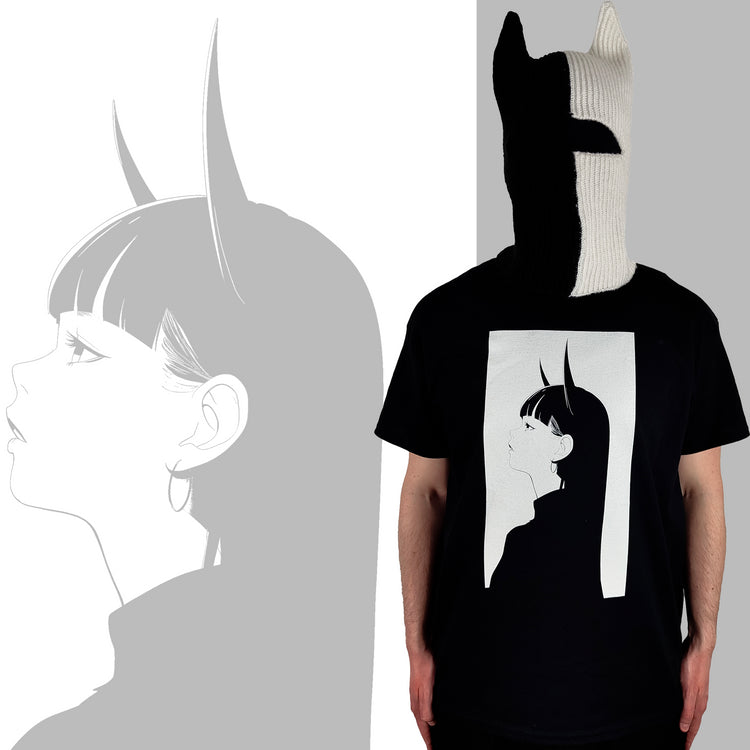 Person wearing a black T-shirt featuring a minimalist anime design of a girl with long hair and horns, with a matching black and white knitted mask with pointed ears, standing against a background displaying an enlarged version of the same anime design.