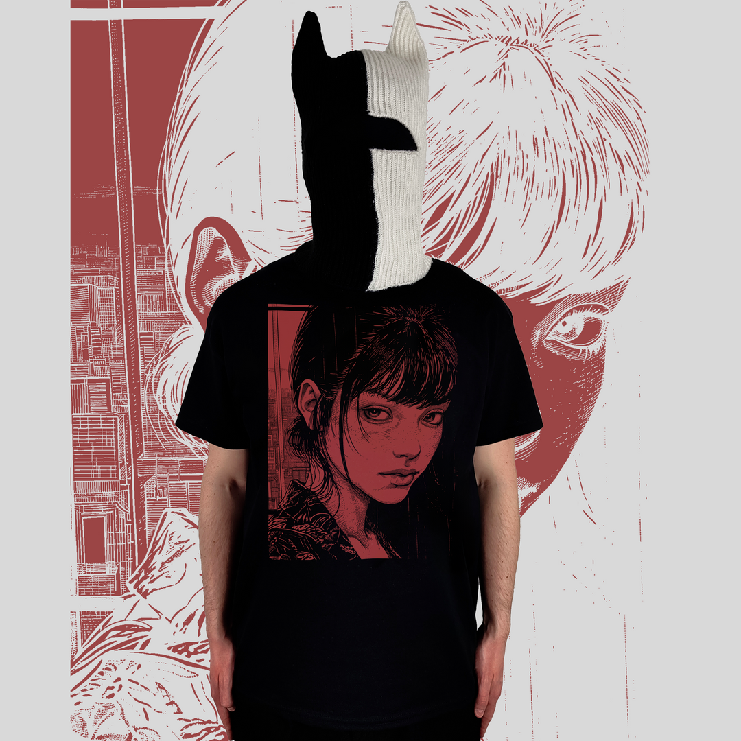 A person wearing a black t-shirt with a striking anime-style illustration of a young woman with a somber expression, rendered in red and black tones, against an urban background. The individual is also wearing a distinctive black and white knit mask that covers their head, adding an artistic and mysterious element to the image. The background mirrors the t-shirt design, emphasizing the theme of isolation in a modern metropolis.
